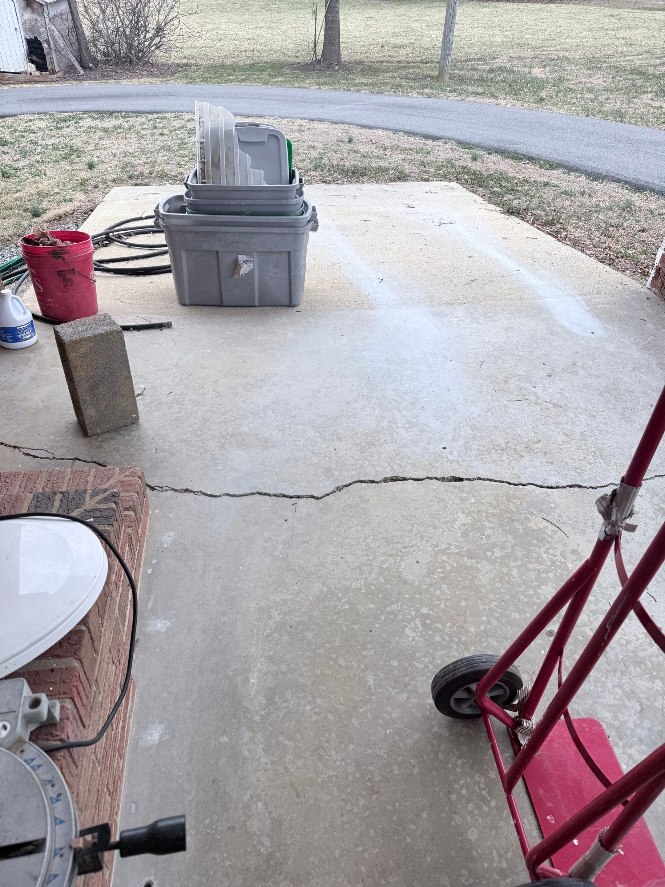 Water pooling on a sunken concrete patio after rain